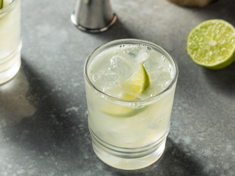 Margarita in a small glass with lots of ice and a lime inside